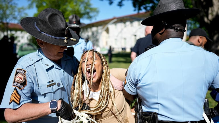 Georgia State Patrol officers detain a demonstrator on the campus...