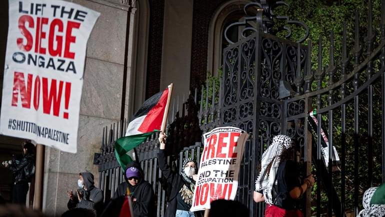 Pro-Palestianian protesters gather near a main gate at Columbia University...