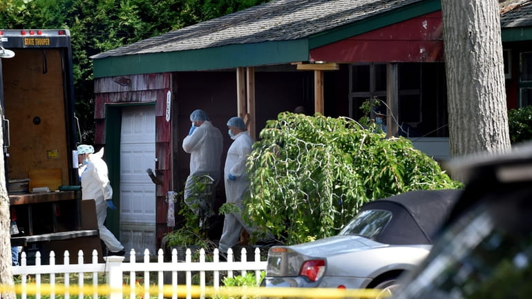 Crime scene police search the Heuermann home, in Massapequa Park,...