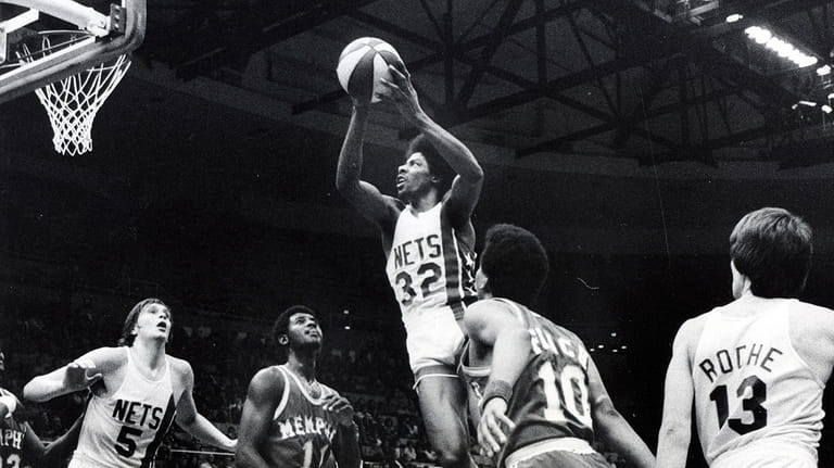 Nets' Julius Erving puts one in during their game at Nassau...
