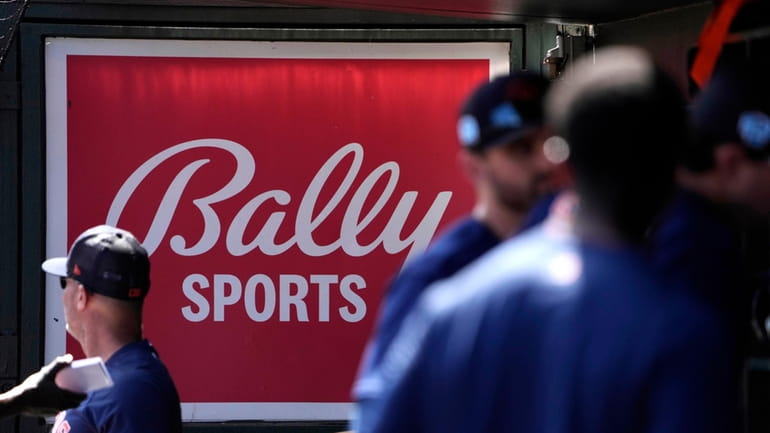 FILE -A Bally Sports sign hangs in a dugout before...