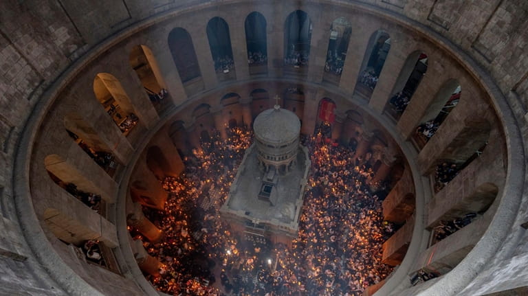 Christian pilgrims hold candles during the Holy Fire ceremony, a...